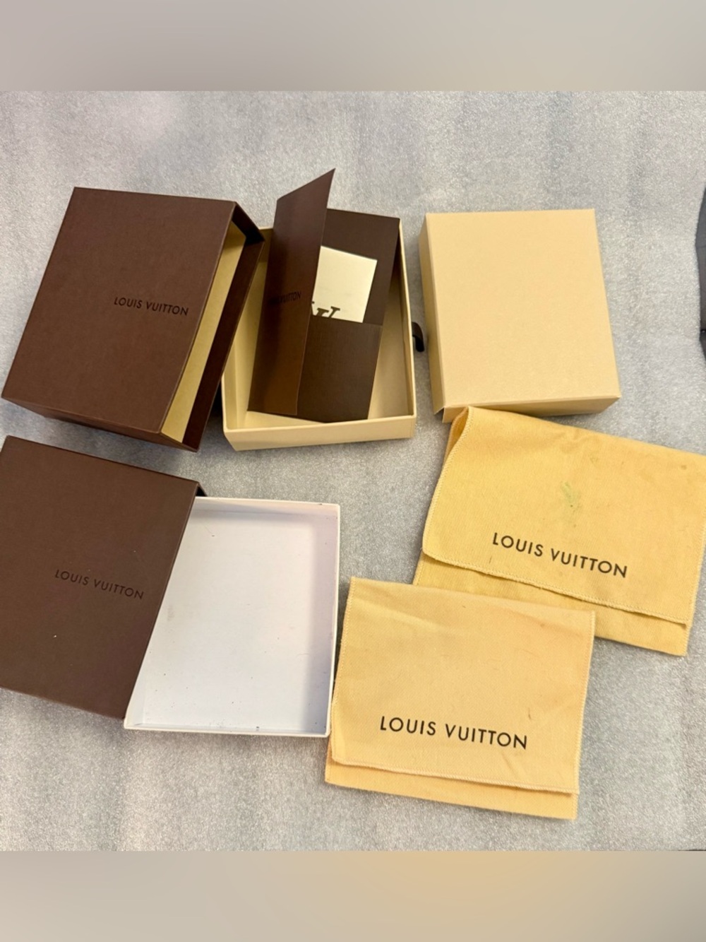 Louis Vuitton lot of boxes and clothes. (W/receipt holders & receipts included)